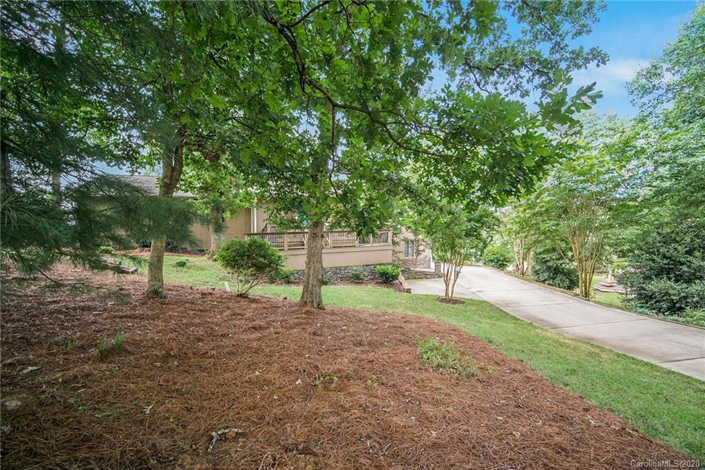 3927 Rounding Run Road Charlotte, NC 28277 - Photo 2 of 48 a green field with lots of trees in the background