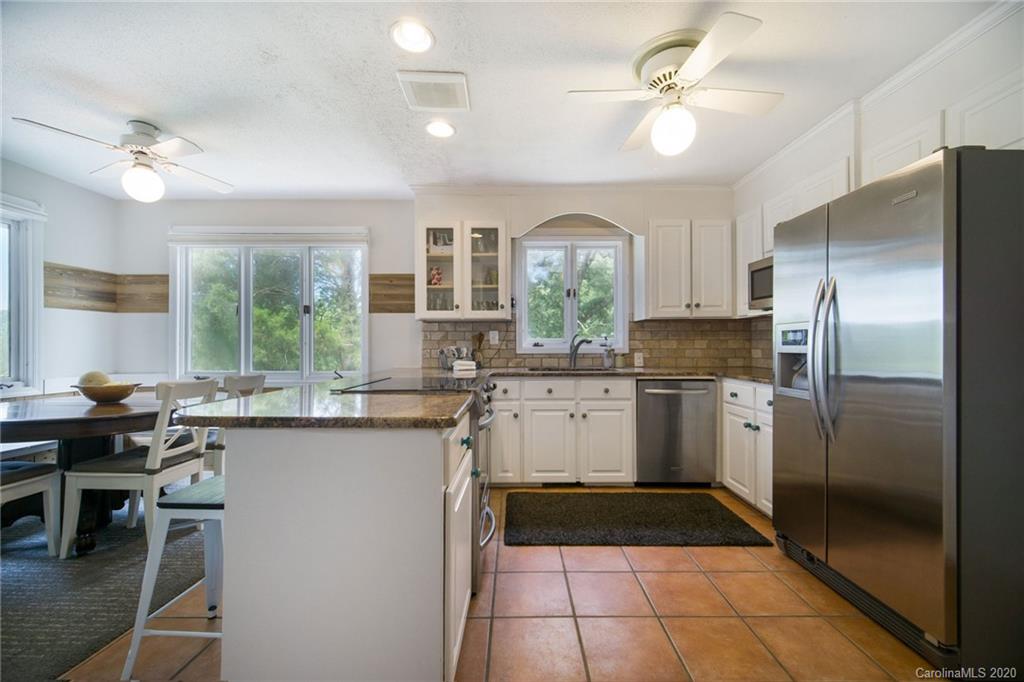 3927 Rounding Run Road Charlotte, NC 28277 - Photo 13 of 48 a kitchen with a refrigerator a sink dishwasher a stove and a refrigerator with wooden floor