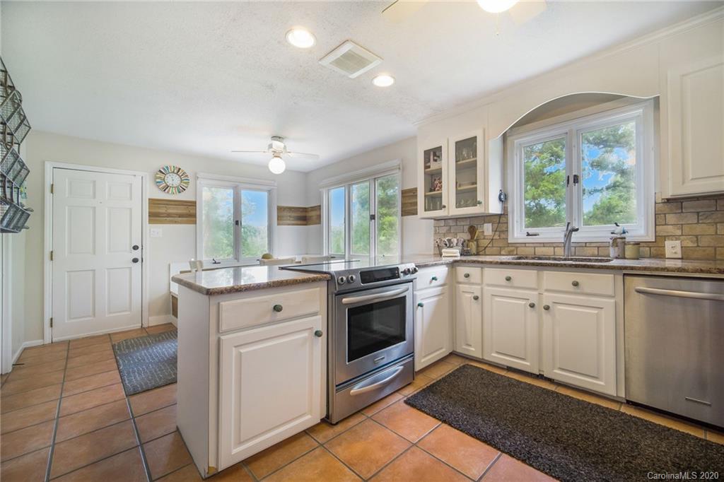 3927 Rounding Run Road Charlotte, NC 28277 - Photo 14 of 48 a kitchen with stainless steel appliances granite countertop a stove a sink and a refrigerator