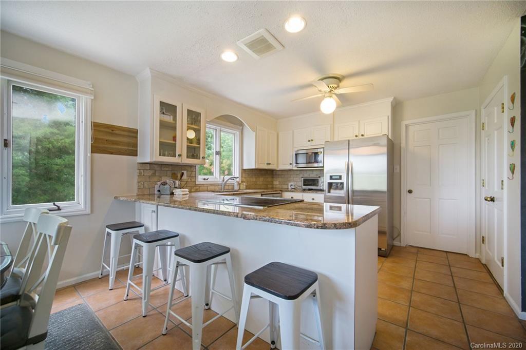 3927 Rounding Run Road Charlotte, NC 28277 - Photo 17 of 48 a kitchen with kitchen island granite countertop a sink stove and refrigerator