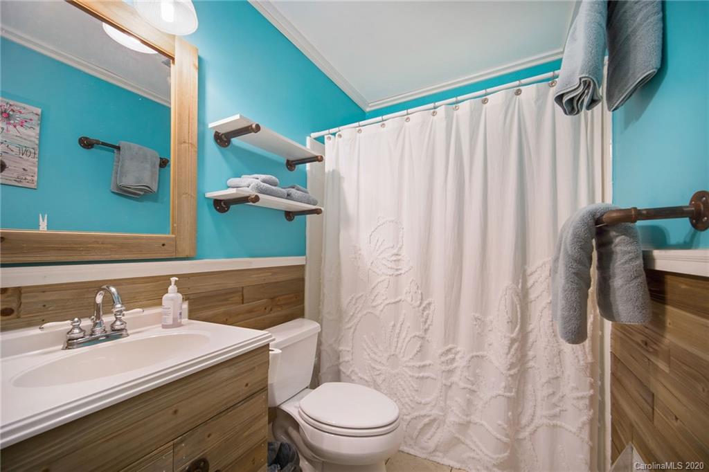 3927 Rounding Run Road Charlotte, NC 28277 - Photo 29 of 48 a bathroom with a sink a toilet and shower