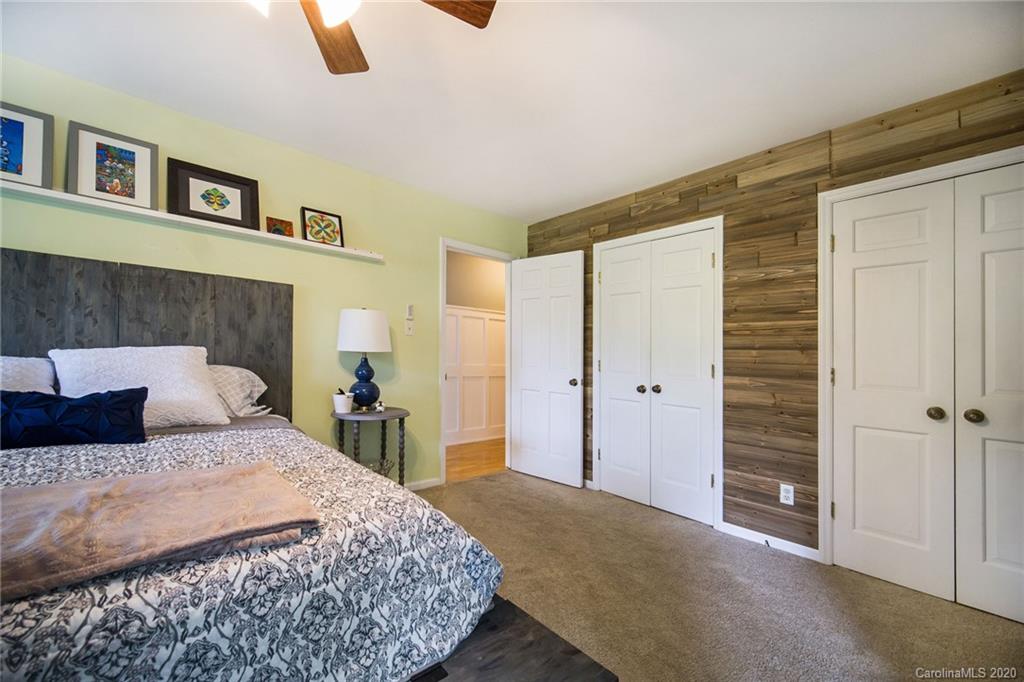 3927 Rounding Run Road Charlotte, NC 28277 - Photo 31 of 48 a bedroom with a large bed and a chandelier