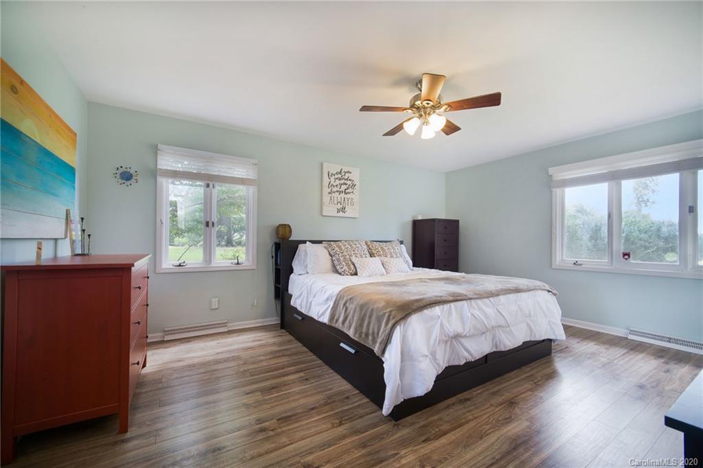 3927 Rounding Run Road Charlotte, NC 28277 - Photo 32 of 48 a bedroom with a large bed and wooden floor