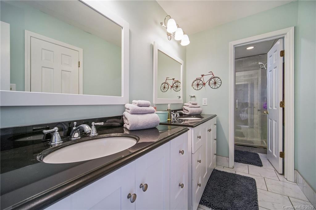 3927 Rounding Run Road Charlotte, NC 28277 - Photo 34 of 48 a spacious bathroom with a double vanity sink a mirror and a shower