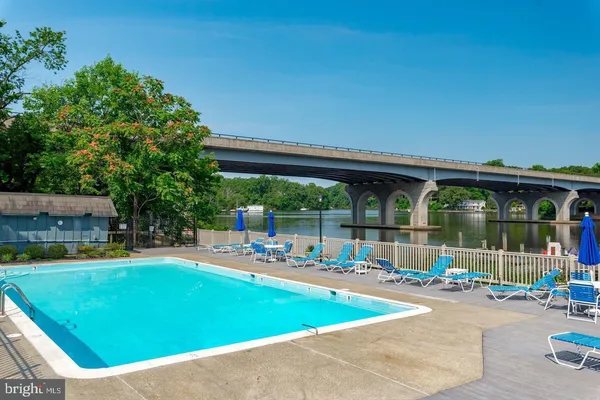 swimming pool view with a seating space and a garden view