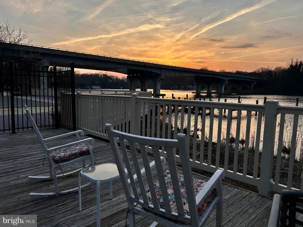 a view of balcony with wooden floor and outdoor seating