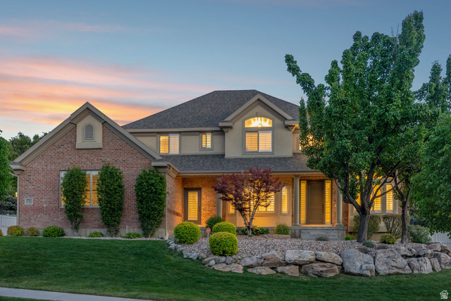 1712 Somerset Ridge Drive Draper, UT 84020 - Photo 3 of 76 Brick and stucco exterior with a covered front porch featuring stone columns and a transom window