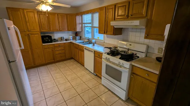 a kitchen with a stove a sink and a refrigerator