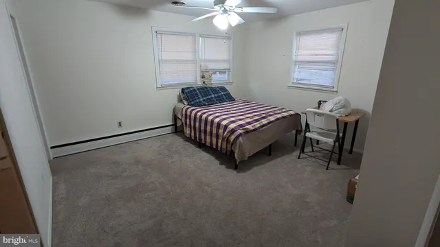 a spacious bedroom with a bed and a chandelier