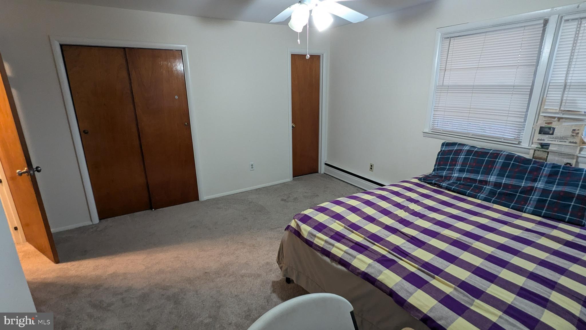 4032 Quakerbridge Road Lawrenceville, NJ 08648 - Photo 9 of 18 a bedroom with a bed and a chandelier
