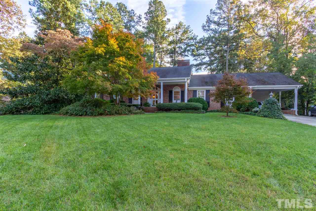 3113 Cartwright Drive Raleigh, NC 27612 - Photo 1 of 25 a view of house in front of a big yard with large trees