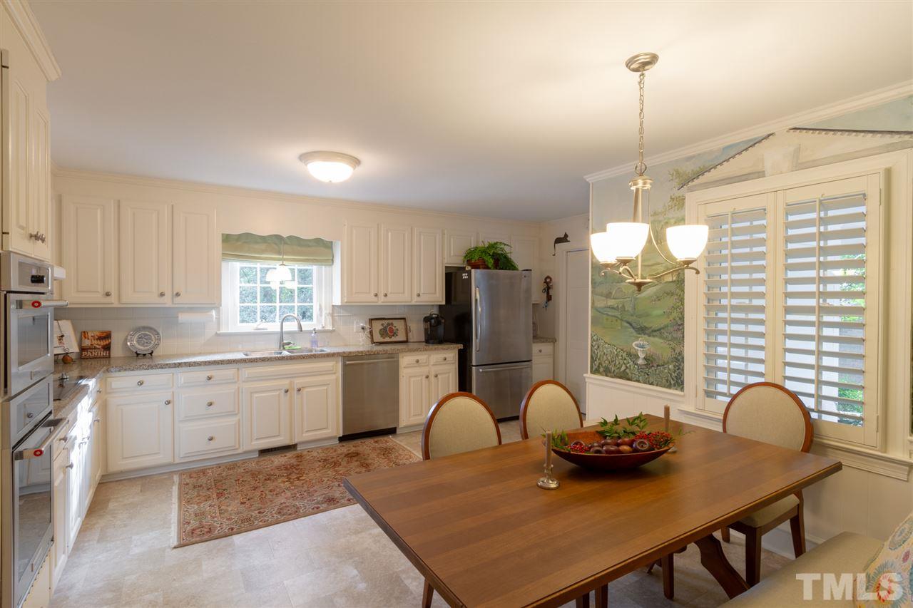 3113 Cartwright Drive Raleigh, NC 27612 - Photo 11 of 25 a open kitchen with dining table and chairs