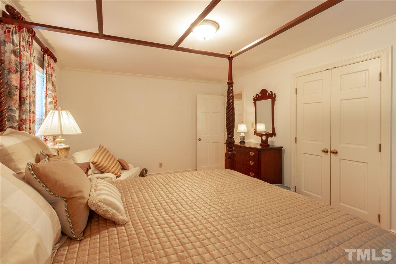 3113 Cartwright Drive Raleigh, NC 27612 - Photo 15 of 25 a bedroom with a bed and a walk in closet