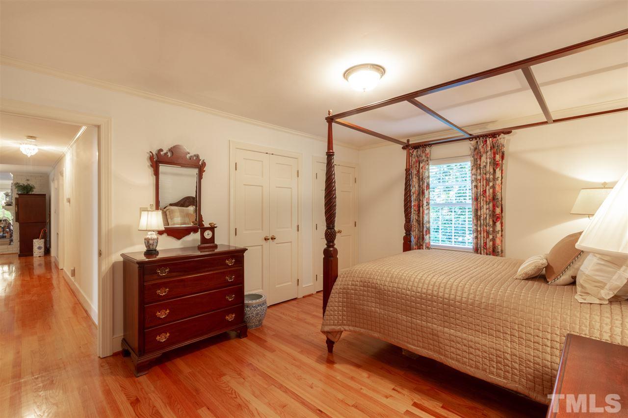 3113 Cartwright Drive Raleigh, NC 27612 - Photo 16 of 25 a bedroom with a bed and wooden floor
