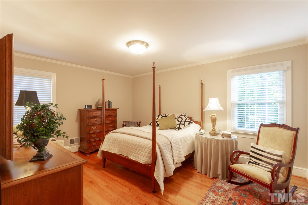 3113 Cartwright Drive Raleigh, NC 27612 - Photo 18 of 25 a bedroom with a bed and a chair