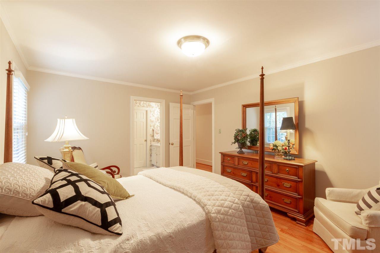 3113 Cartwright Drive Raleigh, NC 27612 - Photo 19 of 25 a bed room with a bed and a lamp
