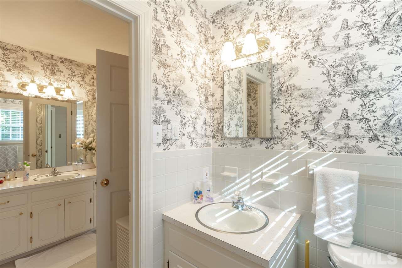 3113 Cartwright Drive Raleigh, NC 27612 - Photo 20 of 25 a bathroom with a sink vanity granite and a mirror