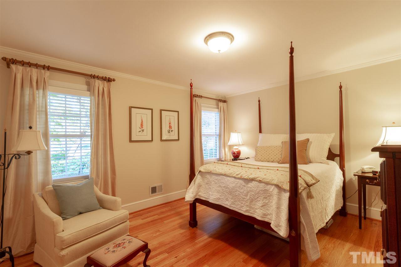 3113 Cartwright Drive Raleigh, NC 27612 - Photo 21 of 25 a bedroom with a bed and wooden floor