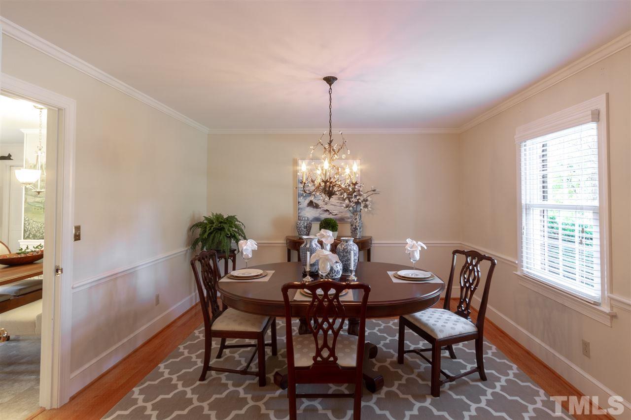 3113 Cartwright Drive Raleigh, NC 27612 - Photo 7 of 25 a dining room with furniture a chandelier and wooden floor