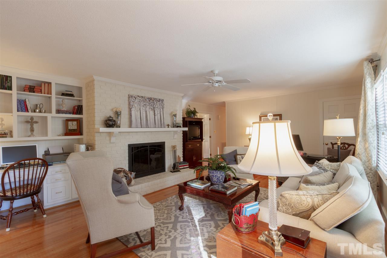 3113 Cartwright Drive Raleigh, NC 27612 - Photo 8 of 25 a living room with furniture and a fireplace