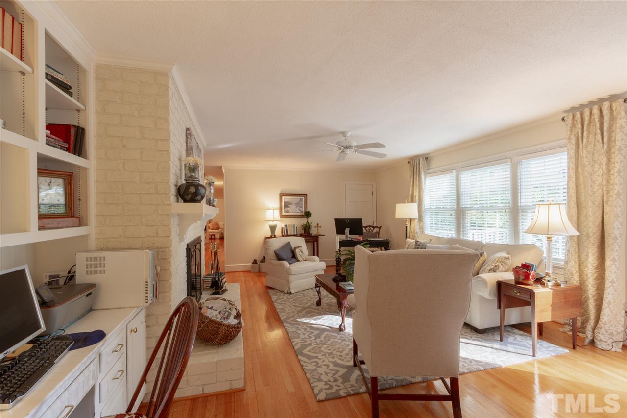 3113 Cartwright Drive Raleigh, NC 27612 - Photo 9 of 25 a living room with furniture a large window and gym equipment
