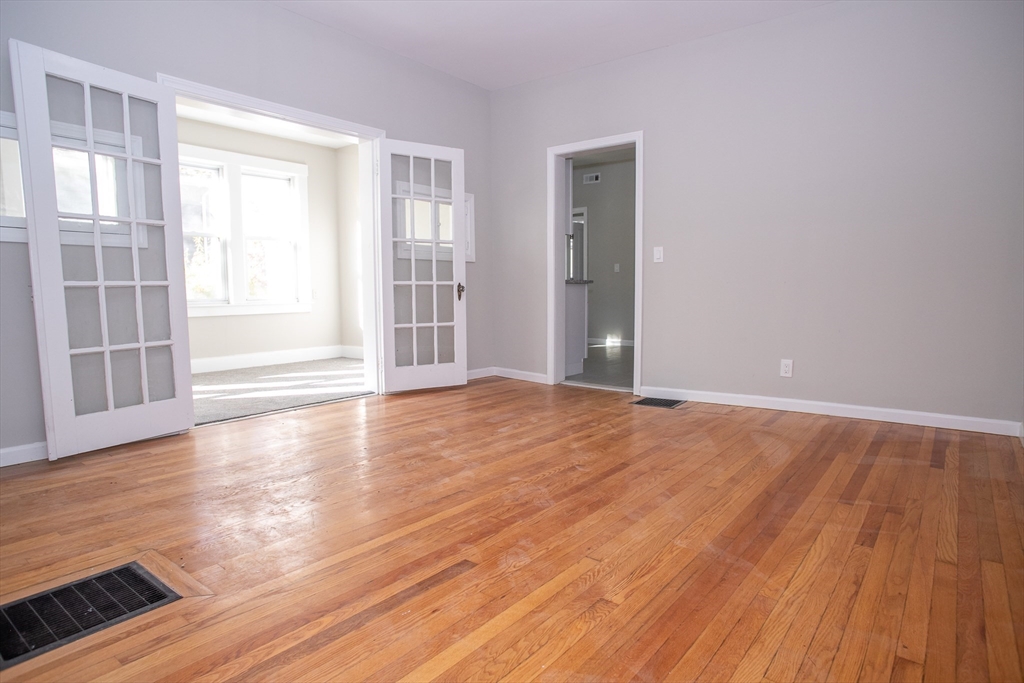 57-59 Cottage Street Athol, MA 01331 - Photo 25 of 42 a view of an empty room with wooden floor and windows