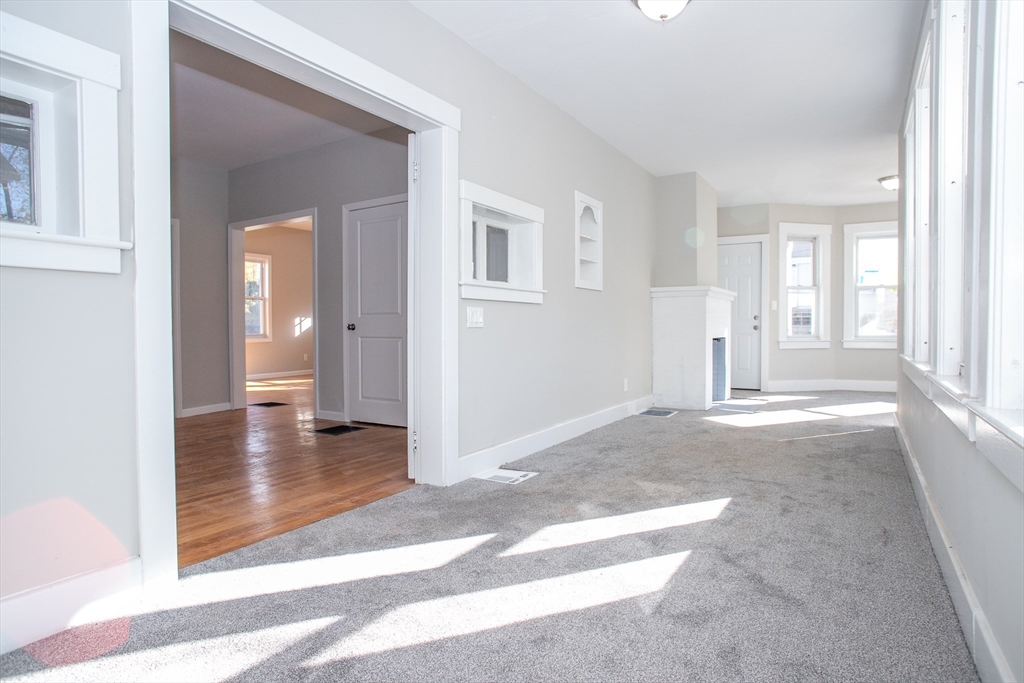 57-59 Cottage Street Athol, MA 01331 - Photo 29 of 42 a view of a hallway with wooden floor and a living room