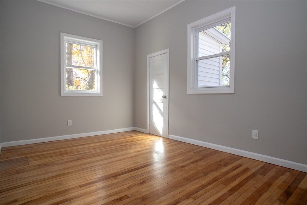 57-59 Cottage Street Athol, MA 01331 - Photo 34 of 42 a view of an empty room with wooden floor and a window