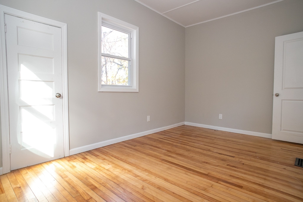 57-59 Cottage Street Athol, MA 01331 - Photo 36 of 42 a view of an empty room with wooden floor and a window