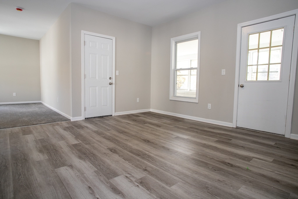 57-59 Cottage Street Athol, MA 01331 - Photo 9 of 42 an empty room with wooden floor and windows