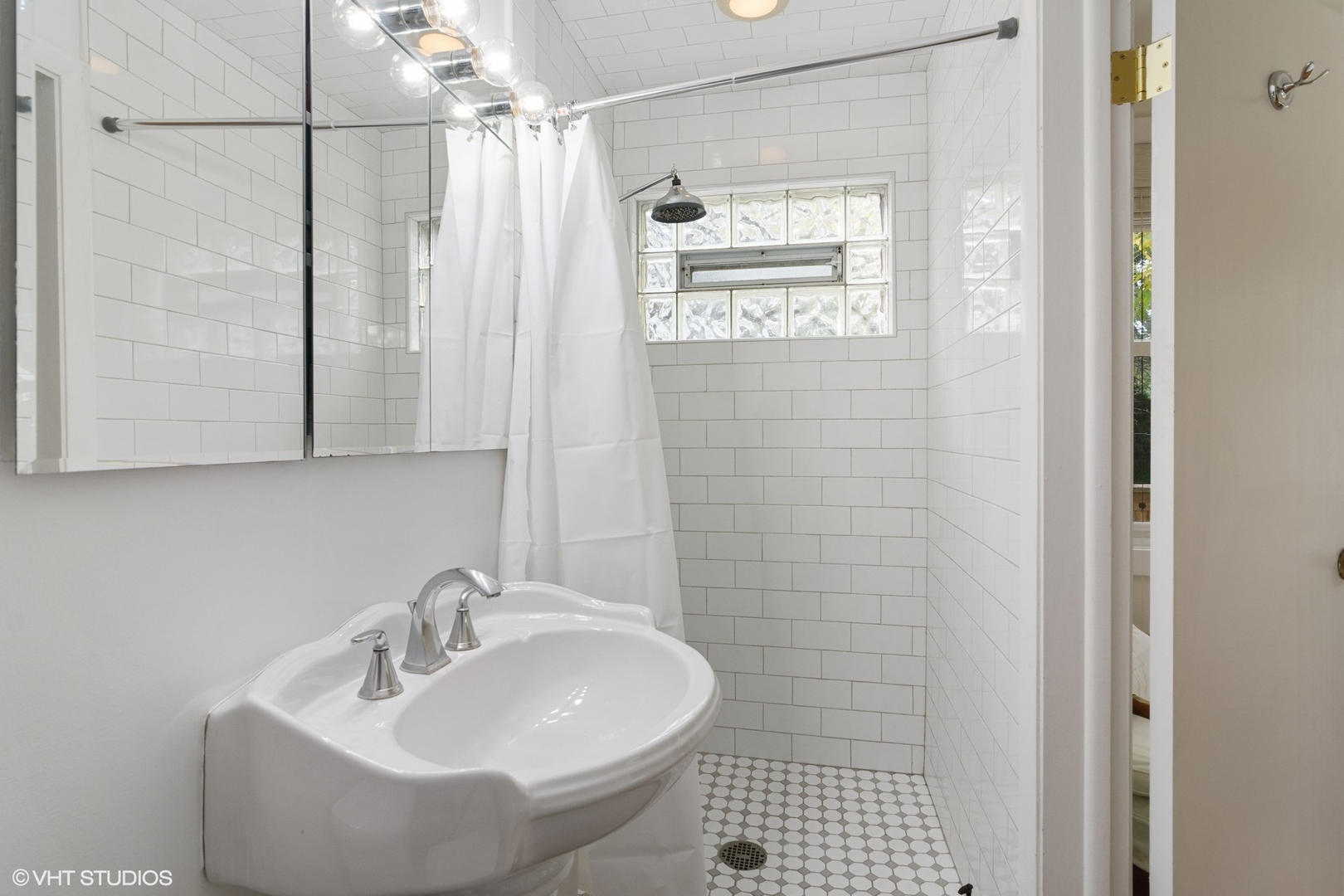 1133 Willow Road Winnetka, IL 60093 - Photo 16 of 26 a bathroom with a sink a toilet and shower