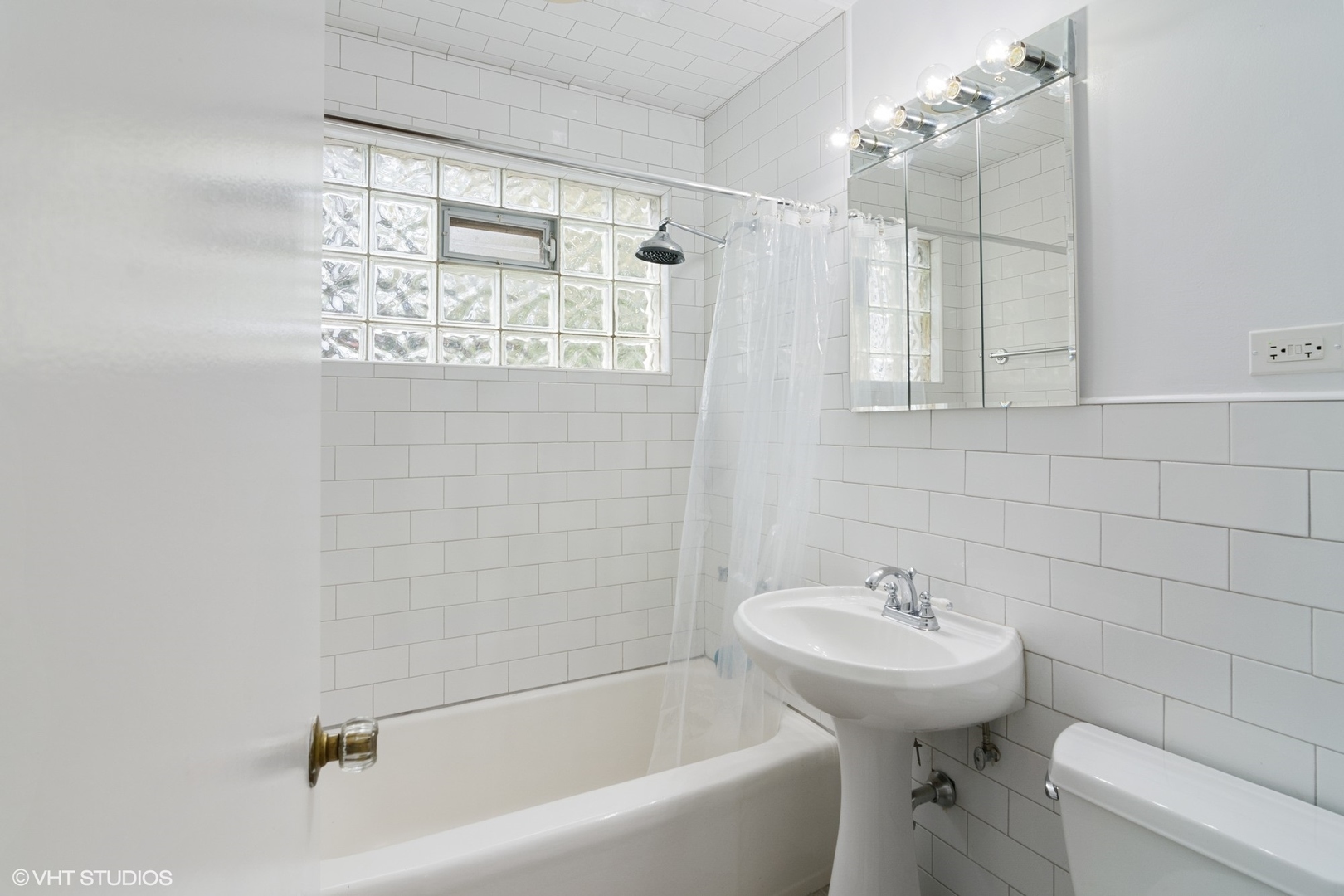 1133 Willow Road Winnetka, IL 60093 - Photo 19 of 26 a bathroom with a sink a toilet and shower