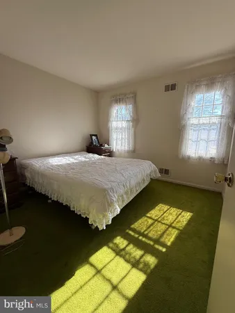 a bedroom with bed and window