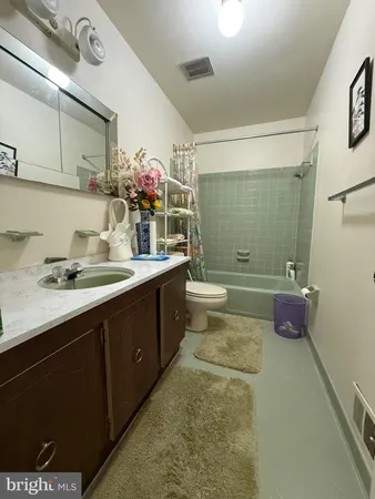a bathroom with a double vanity sink toilet and shower