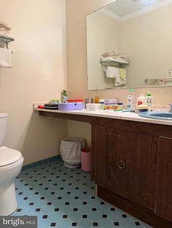 a bathroom with a sink toilet and mirror