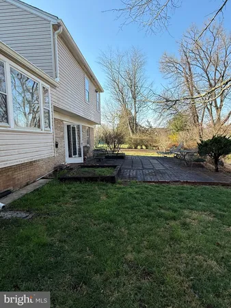 a view of house with backyard and garden