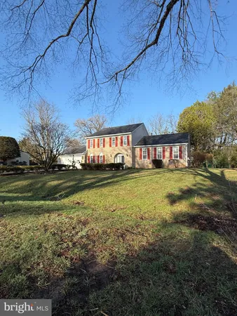 a view of a yard with a house in the background