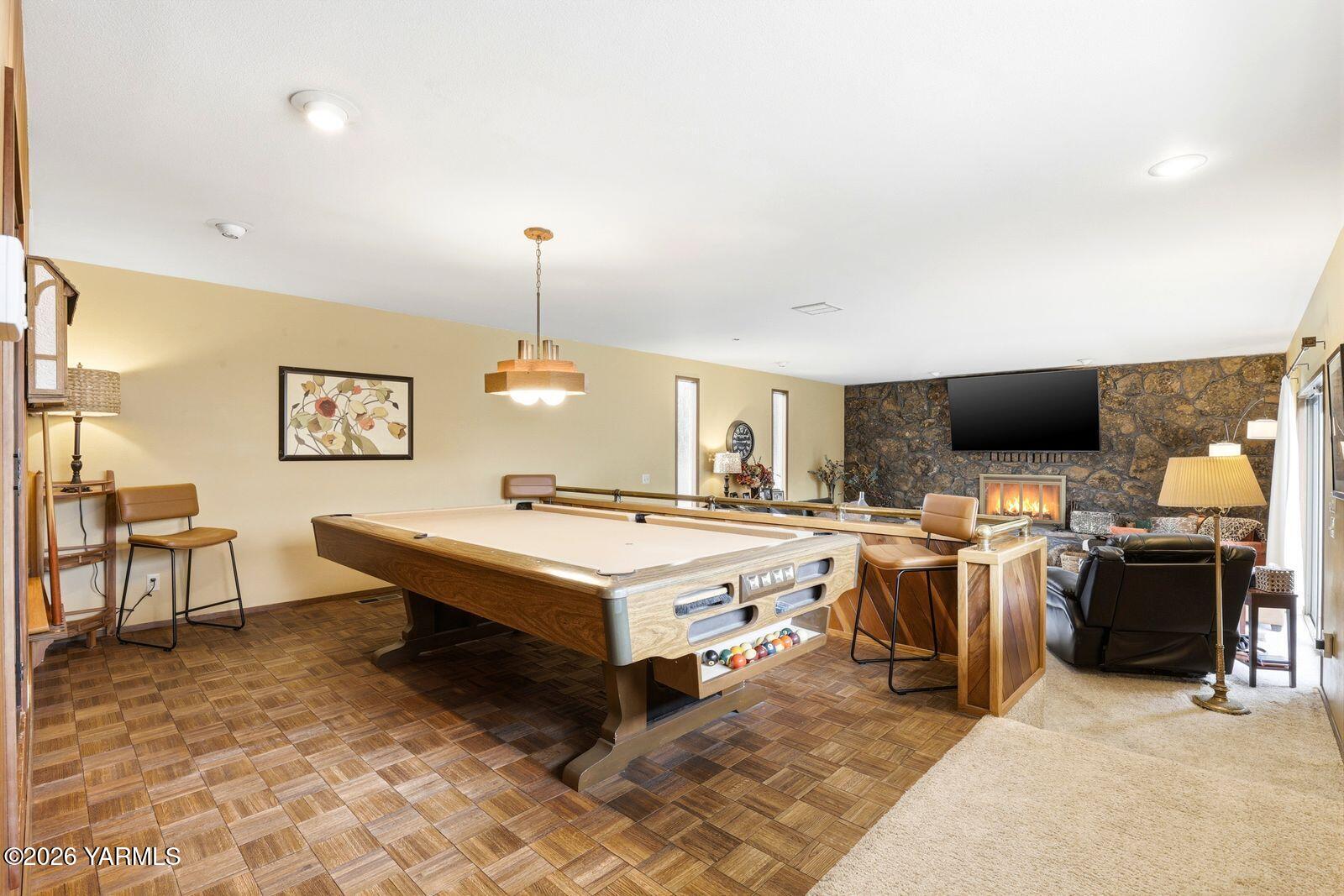 212 South 46th Avenue Yakima, WA 98908 - Photo 11 of 31 a living room with a flat screen tv and a fireplace