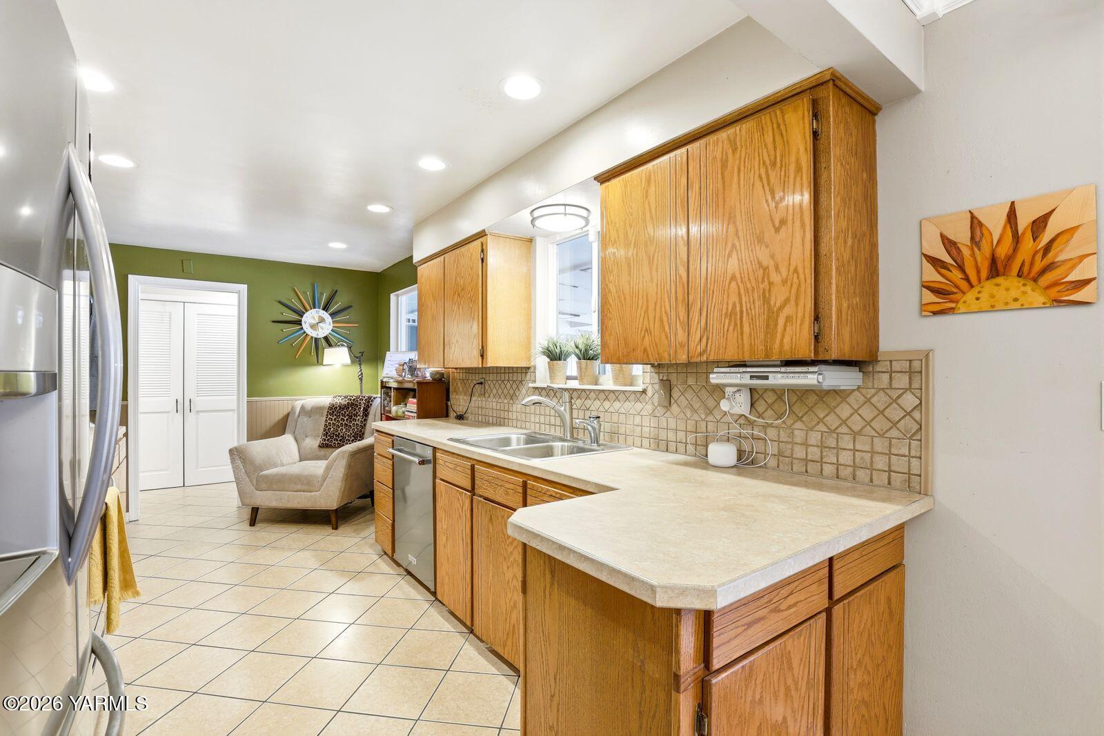 212 South 46th Avenue Yakima, WA 98908 - Photo 6 of 31 a kitchen with a sink stove and cabinets