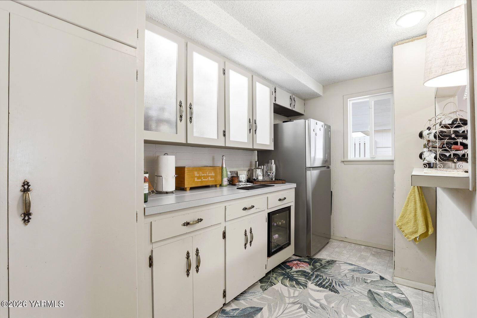 212 South 46th Avenue Yakima, WA 98908 - Photo 10 of 31 a kitchen with stainless steel appliances a stove a refrigerator and cabinets