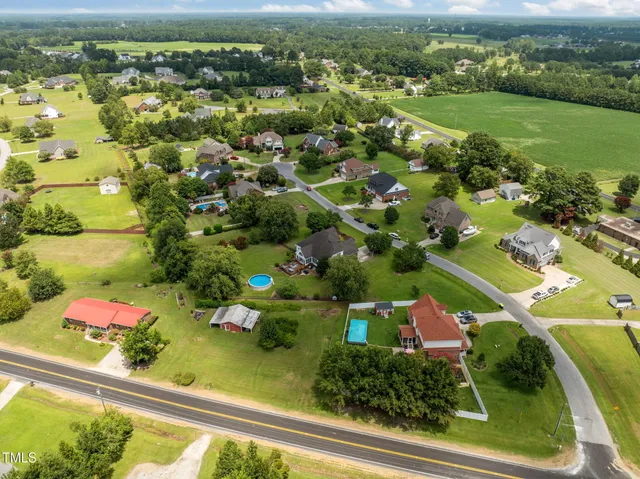 an aerial view of residential houses with outdoor space and street view