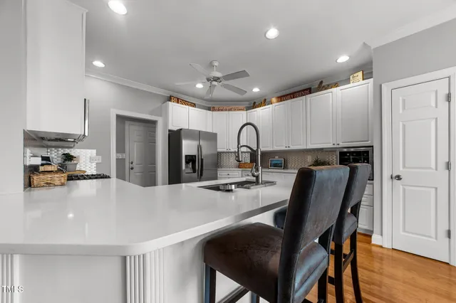 a kitchen with refrigerator cabinets and wooden floor