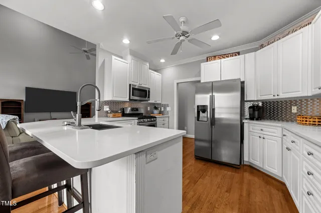 a kitchen with a sink a stove and cabinets
