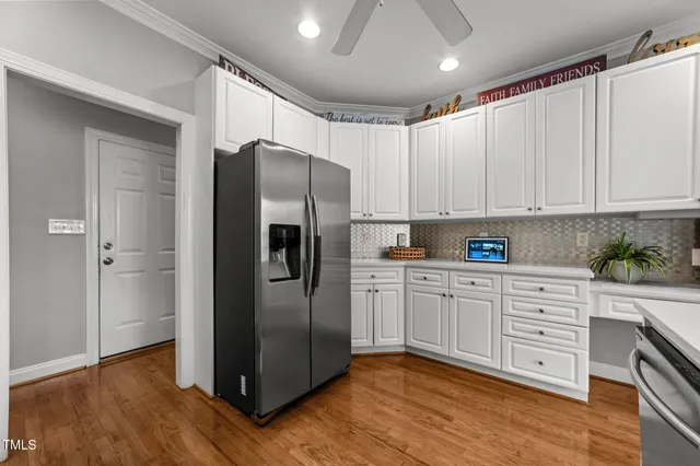 a dining room with furniture a chandelier and wooden floor