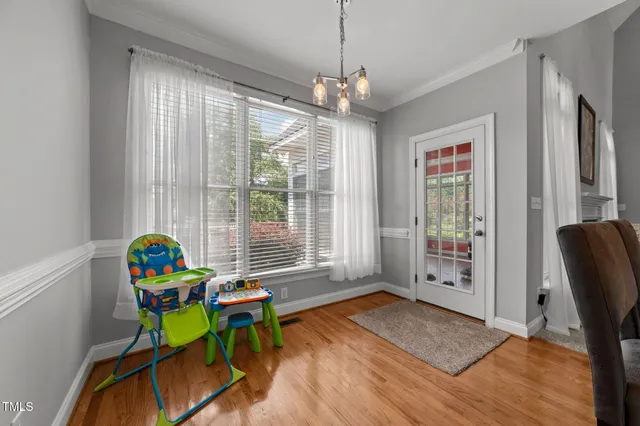 a view of a dining room with furniture window and wooden floor