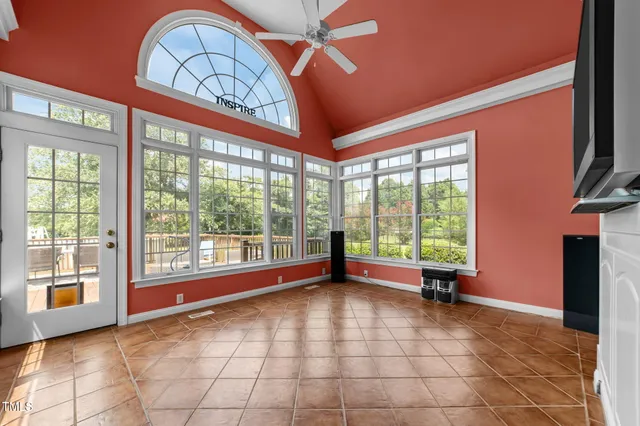 a spacious bedroom with a bed and a chandelier