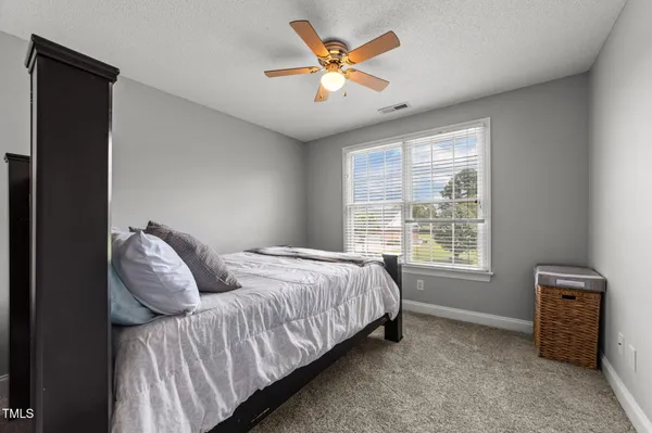 a bedroom with furniture and a chandelier