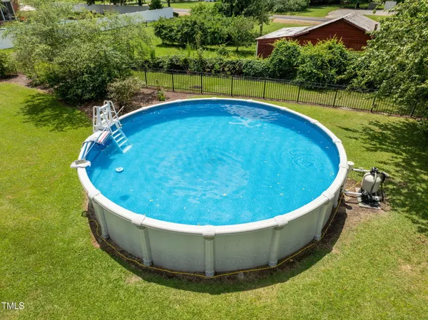 a view of a swimming pool with a yard