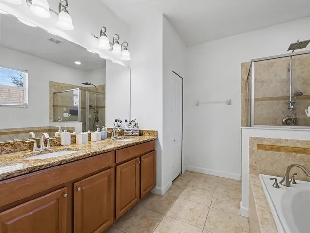 a bathroom with a sink double vanity granite and a mirror