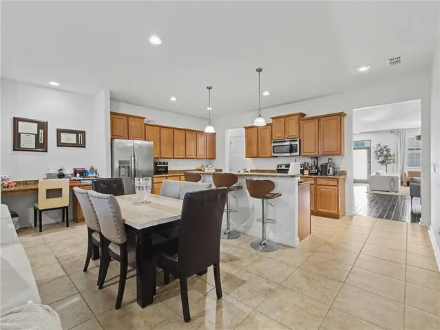 a large kitchen with a table and chairs